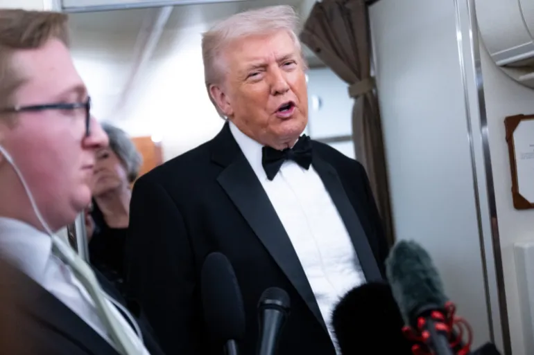 US President Donald Trump speaks to members of the media aboard Air Force One as he travels from Washington, DC to West Palm Beach, Florida, on January 31, 2026.