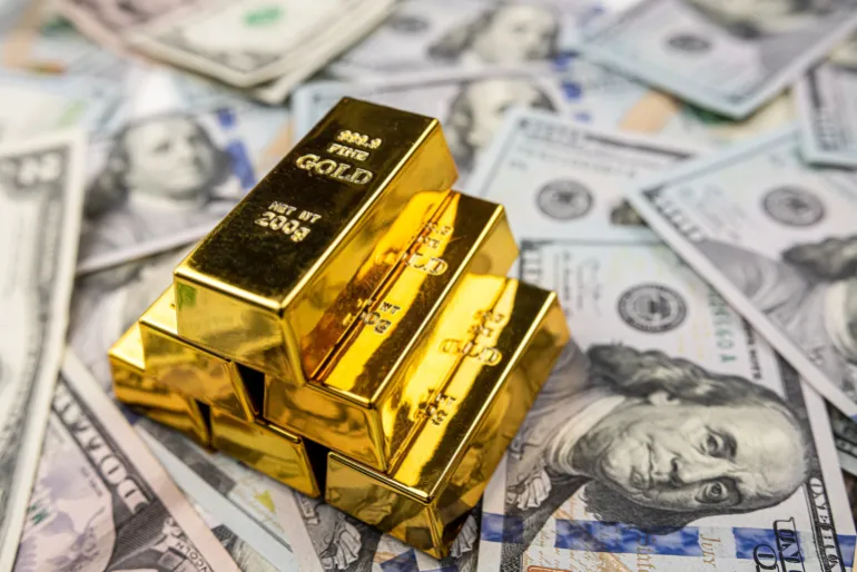 Gold bullion over 100 us dollar money, investment and wealth concept. Close-up