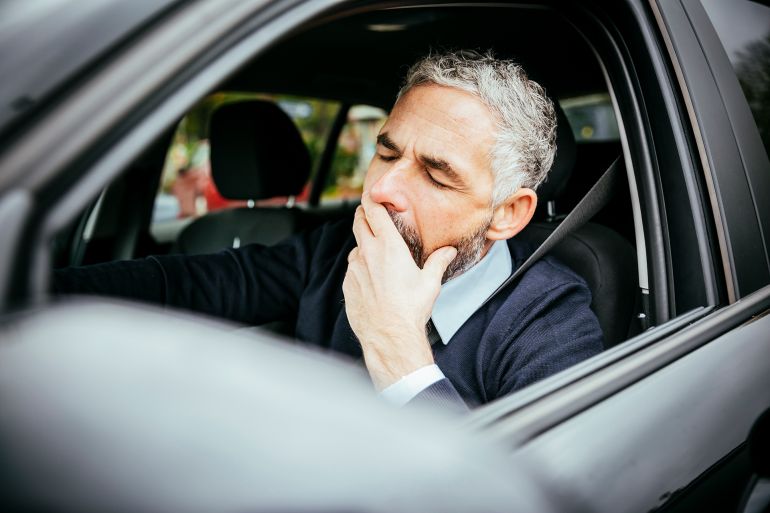 Tired man in car, Vienna, Austria