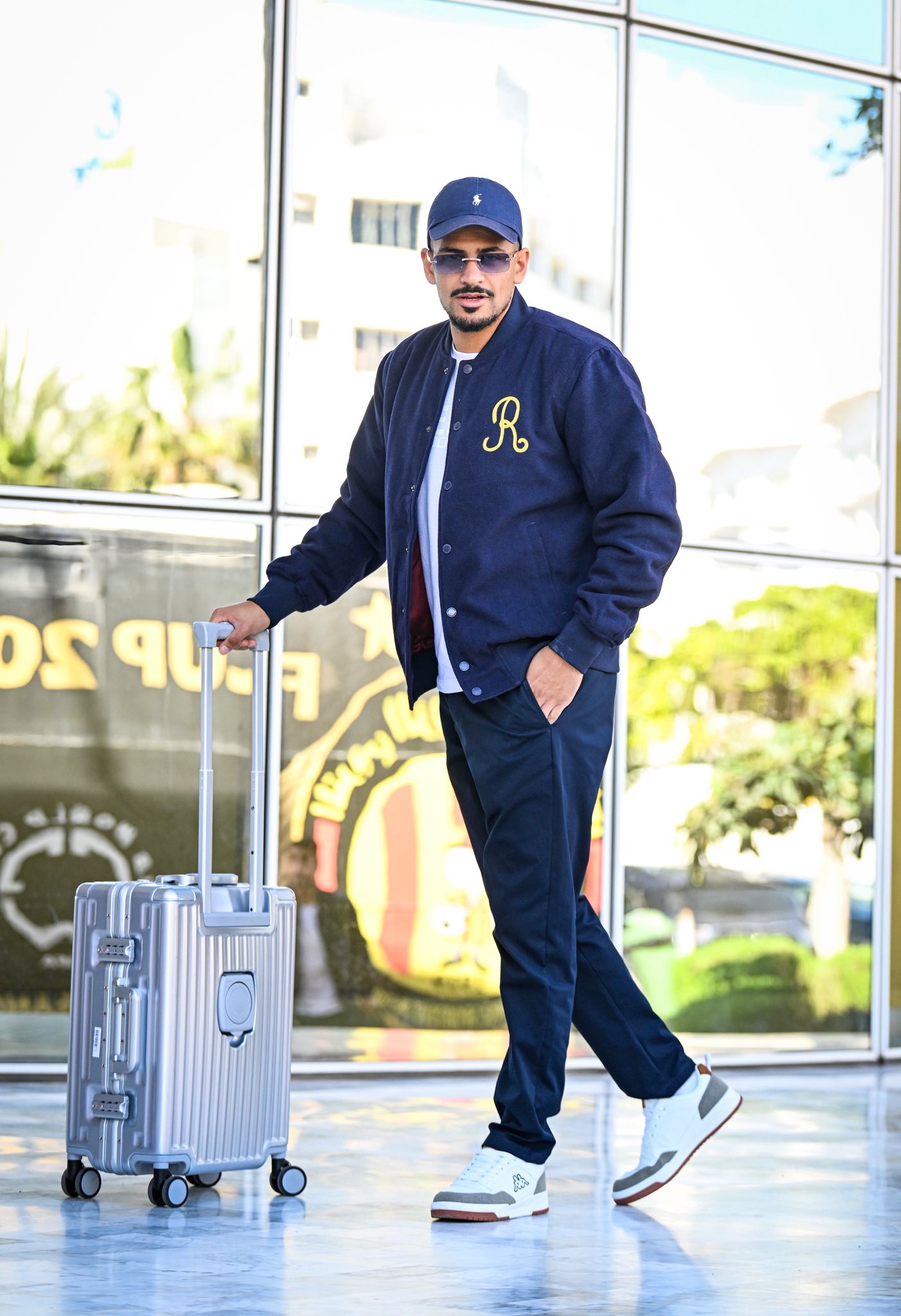 May be an image of suitcase, hat and text