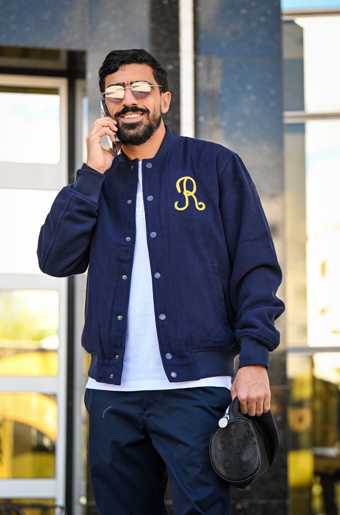 May be an image of one or more people, beard and text that says "R"