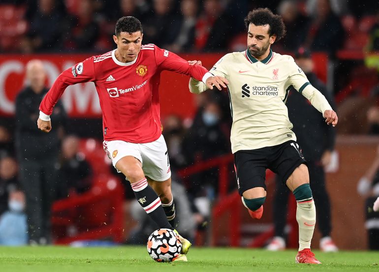 MANCHESTER, ENGLAND - OCTOBER 24: Cristiano Ronaldo of Manchester United holds off Mohamed Salah of Liverpool during the Premier League match between Manchester United and Liverpool at Old Trafford on October 24, 2021 in Manchester, England. (Photo by Michael Regan/Getty Images)