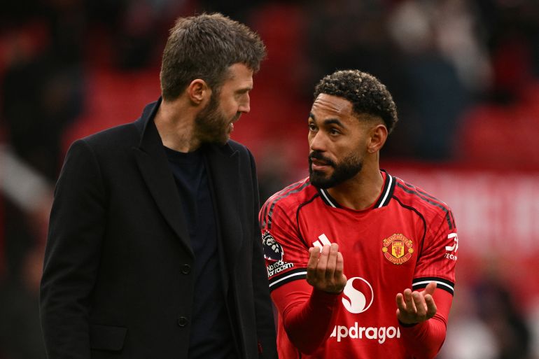 Manchester United's Brazilian striker #10 Matheus Cunha (R) speaks with Manchester United's English interim head coach Michael Carrick (L) at the end of the English Premier League football match between Manchester United and Aston Villa at Old Trafford in Manchester, north west England, on March 15, 2026. (Photo by Oli SCARFF / AFP) / RESTRICTED TO EDITORIAL USE. NO USE WITH UNAUTHORIZED AUDIO, VIDEO, DATA, FIXTURE LISTS, CLUB/LEAGUE LOGOS OR 'LIVE' SERVICES. ONLINE IN-MATCH USE LIMITED TO 120 IMAGES. AN ADDITIONAL 40 IMAGES MAY BE USED IN EXTRA TIME. NO VIDEO EMULATION. SOCIAL MEDIA IN-MATCH USE LIMITED TO 120 IMAGES. AN ADDITIONAL 40 IMAGES MAY BE USED IN EXTRA TIME. NO USE IN BETTING PUBLICATIONS, GAMES OR SINGLE CLUB/LEAGUE/PLAYER PUBLICATIONS.